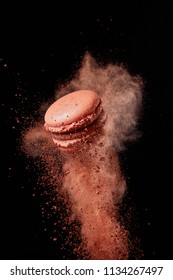 French Chocolate Macaron With Cocoa Powder Against Black Background