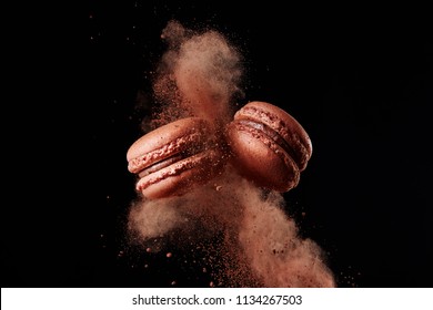 French Chocolate Macaron With Cocoa Powder Against Black Background