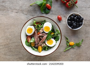 French Composed Salad With Tuna, Anchovy, Hard-boiled Eggs, Tomatoes, And Black Olives.