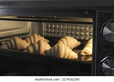 The French Croissant Dough Baking Process In The Oven. A Croissant Made With Premium Ingredients. Cooking Process.