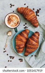 French croissant roll with coffee. Appetizing breakfast with pastries. View from above
