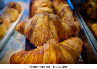 French Croissants On Display At Local Bakery In Glass Case