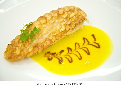 French Cuisine Fried Potatos Shell Sea Bass With Lemon Sauce Fish Dish In Lyon In France