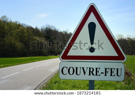 French curfew danger sign concept on the side of a country road