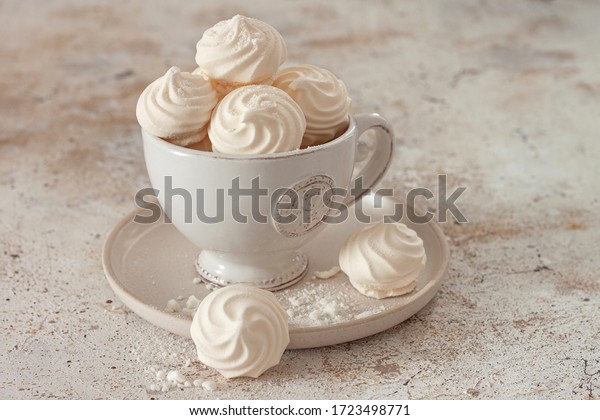 French dessert Meringue\
prepared from whipped with sugar and baked eggs.A cup of home-made\
meringues 