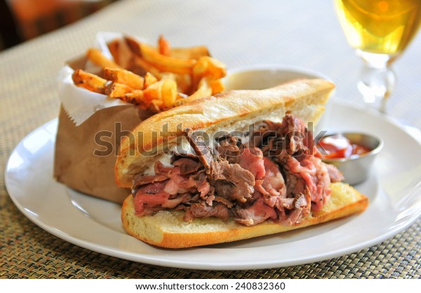 French Dip Sandwich -\
Juicy smoked prime rib sandwich on a crunchy French baguette\
smeared with horseradish sauce, and thinly sliced medium rare prime\
rib and Swiss cheese.