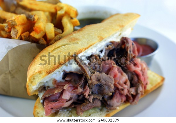 French Dip Sandwich -\
Juicy smoked prime rib sandwich on a crunchy French baguette\
smeared with horseradish sauce, and thinly sliced medium rare prime\
rib and Swiss cheese.