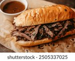 French dip sandwich with roast beef served with au jus on the side, professional food photo, top-down view composition, emphasizing detail and texture of the sandwich.