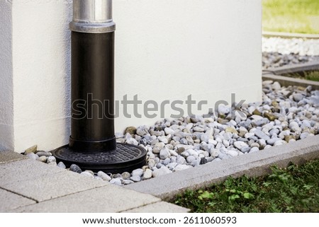 French Drain with Downspout Gutter Pipe around Building Facade. Runoff Drain System of Perimeter House. Modern Underground Gutter System.