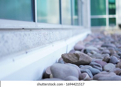 French Drain With Water Stones To Accent Marble Wall And Glass Window