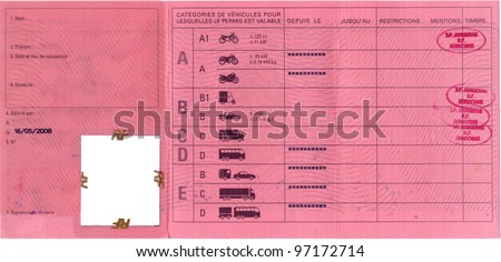 A french / european driving license, inside page with description of permitted driving vehicles, red, with passing stamps