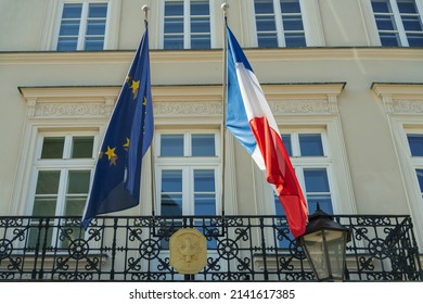 French and European Union flags and the emblem of the French Consulate General in Krakow, Poland on a sunny day - Shutterstock ID 2141617385