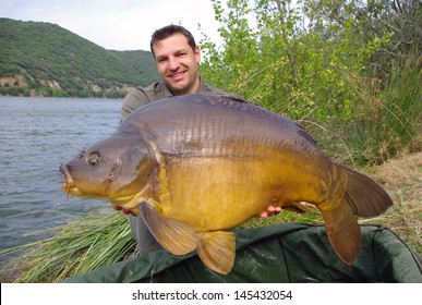 French Fisherman Holding A Giant Mirror Carp.