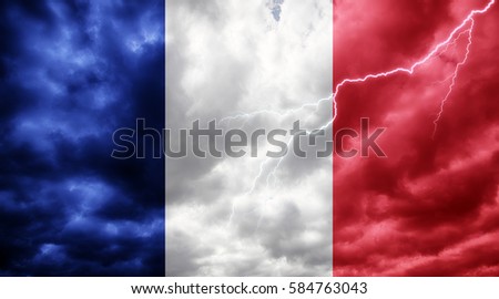 French flag against dark sky, clouds and lightning