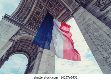 french flag at arc de triomphe during bastille day
