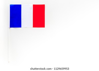 French Flag Concept. Small Flag On White Background Top View Copy Space