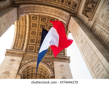 French flag waving under Arc de Triomphe in honor of VE day.