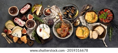 French food assortment on dark background. Traditional cuisine concept. Top view, flat lay, panorama