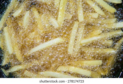 French Fried Potatoes Frying In Boiling Oil