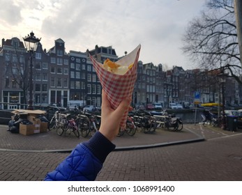 French fries in Amsterdam. Canals in the background