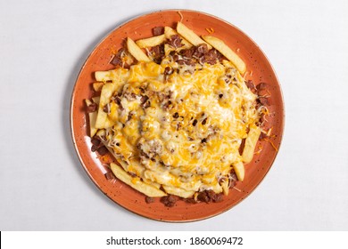 French Fries With Bacon And Cheese On A White Background