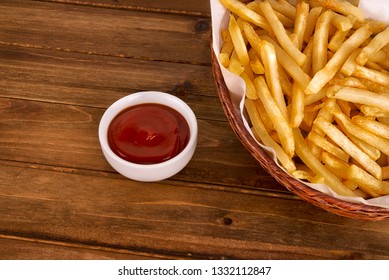 French Fries In A Basket On Wooden Table. Fast Food Restaurant Concept. Directly Above.