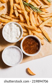 French Fries And Bowls With Salt, Ketchup And Dip.