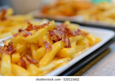 French Fries And Cheese With Bacon On Top  In A White Bowl