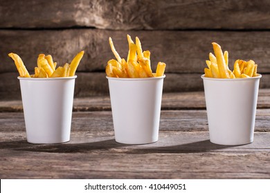 French fries in cups. Cups of fries on table. Standard portions of snack. Well-made fries in cafe. - Powered by Shutterstock