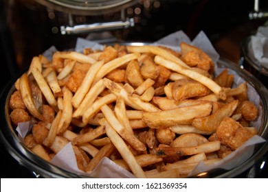 French Fries And Deep Fried Potato Wedges Mixed In A Large Buffet Tray.