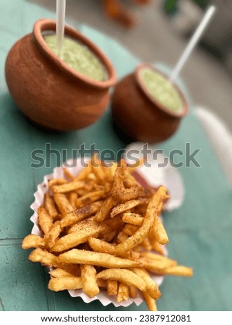 French fries in a different style with desi drink of mint margreta