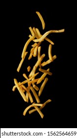 French fries flying in the air isolated on black background, Stop motion
