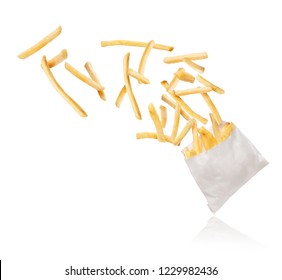 French fries flying out of paper packaging on white background