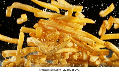 French fries - fried potatoes flying. Fly fastfood isolated on black background. - Shutterstock ID 2280235291