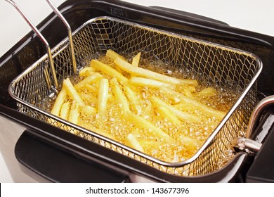 French Fries In Hot Fat In A Deep Fryer