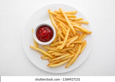 French Fries With Ketchup On A White Plate.