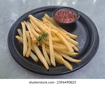 French Fries On Black Plate With Spicy Sauce - Shutterstock ID 2396490825