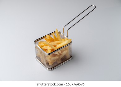 French Fries Potato In Deep Fry Basket Isolated On White