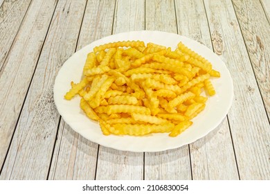 French fries are prepared by cutting them into slices or sticks and frying them in hot oil until golden brown, removing them from the oil and then seasoning them with salt.