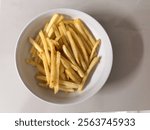 French Fries with salt and pepper in white bowl - kentang goreng dengan garam dan lada putih di mangkuk putih