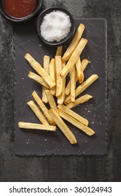 French Fries With Sea Salt And Ketchup, On Black Slate.  Overhead View.