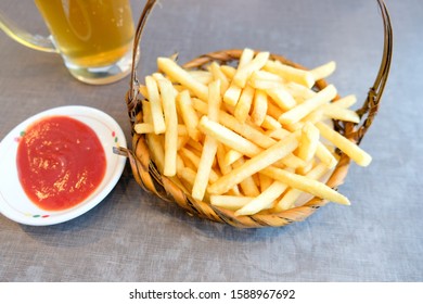 French Fries Served In Basket And Cold Of Beer In Cold Weather