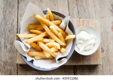 French Fries Top View On Wooden Table Background