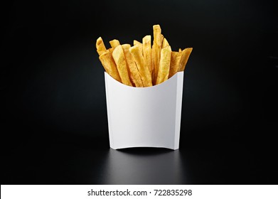 French Fries In A White Paper Box Isolated On Black Background. Front View.