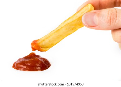 French Fry Being Dipped In Ketchup Over White