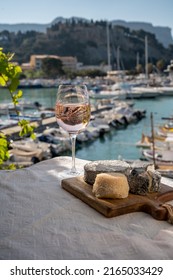 French Goat Cheeses Crottin And Selles-sur-cher Served With View On Boats In Harbor Of Cassis, Provence, France, Cheese Tasting With Glass Of Dry Rose Privencal Wine