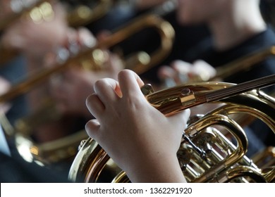 French Horn And Child Hands. Musical Brass Instruments, Adults And Children. Concert In The School. 