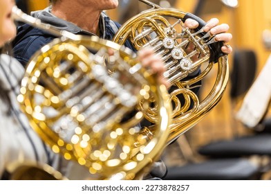 French horn instrument, hands playing horn player in philharmonic orchestra