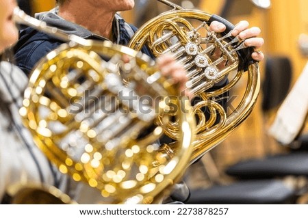 French horn instrument, hands playing horn player in philharmonic orchestra