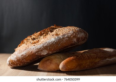 French loaf, bread and ciabatta on a black background - Shutterstock ID 764050399